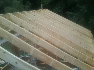 New roof rafters set over an addition before sheathing in Baldwinville
