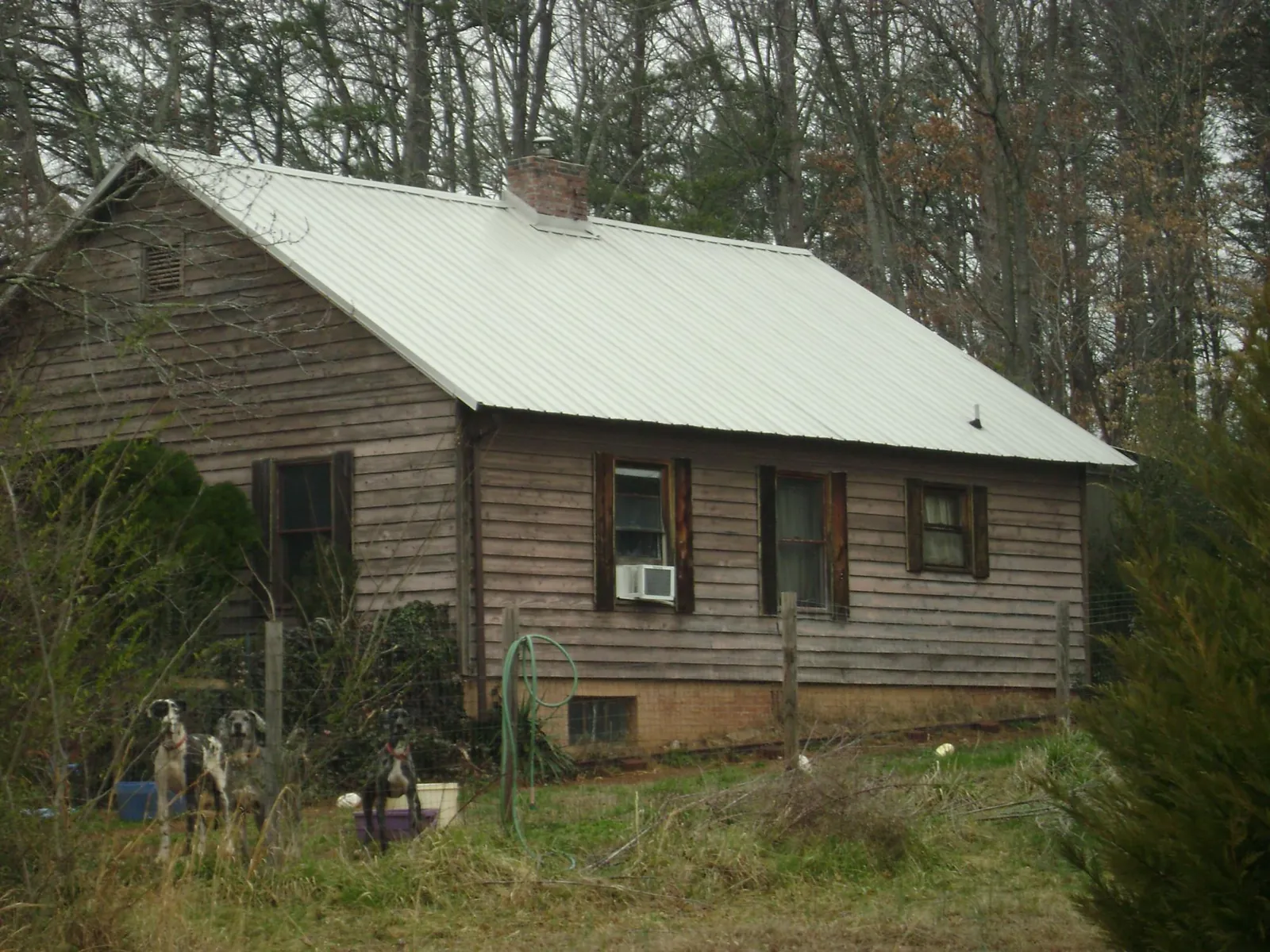 White metal roof on an old wood sided farmhouse, from a Metal Roof Installation job in Baldwinville